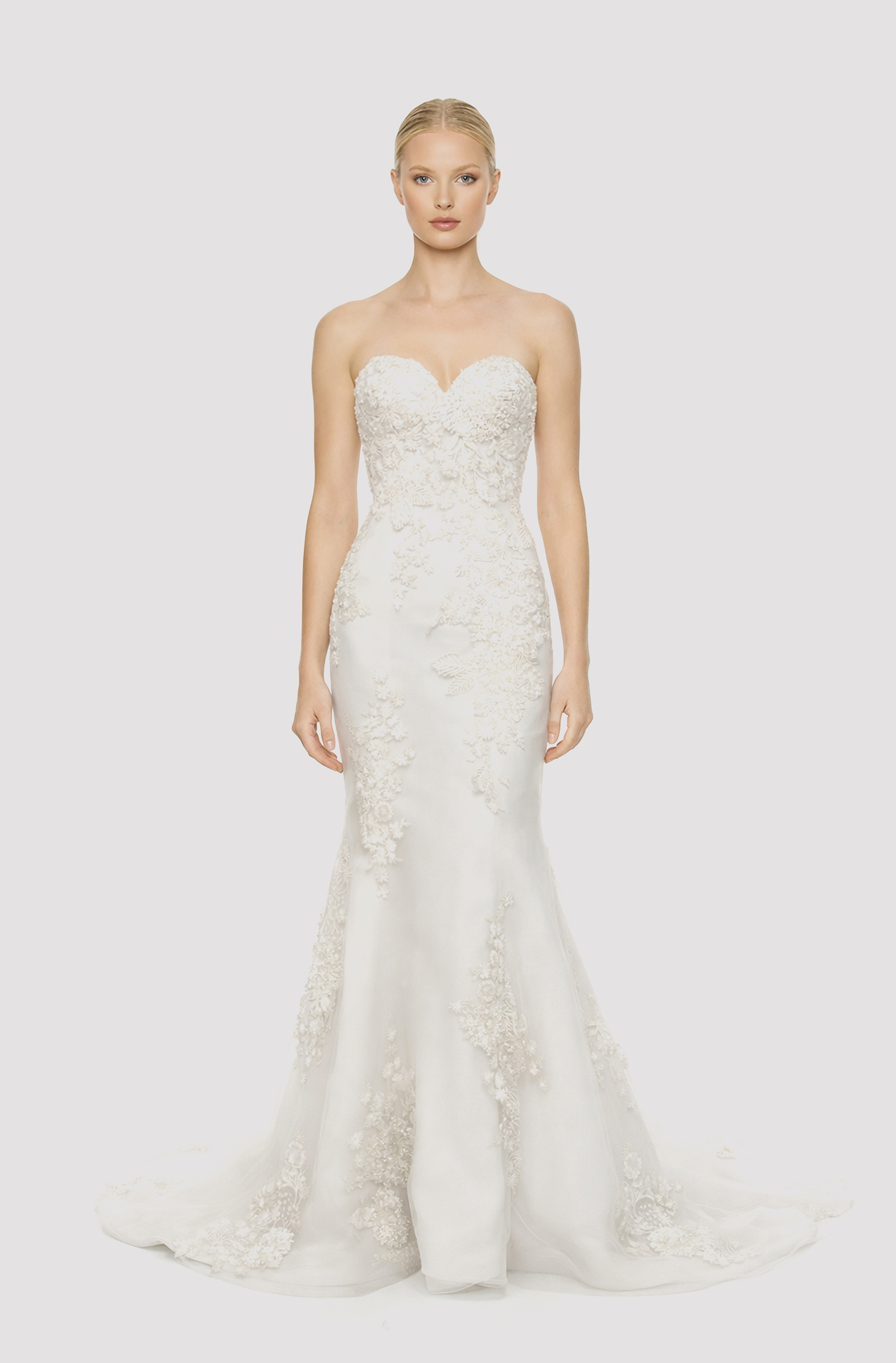 Front view of a woman in an Off-white tulle sweetheart neckline mermaid gown with bodice embellished with hand-beaded lace 10, image 1