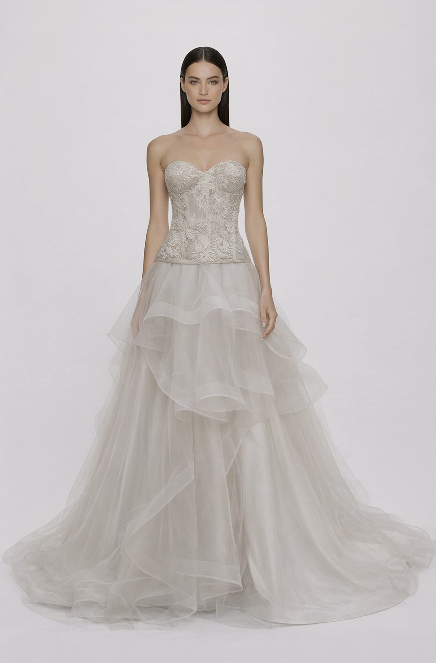Front view of a woman in an Off-white tulle two-piece ensemble with French lace corset featuring lace applique and an asymmetrical skirt with horsehair 23, image 1