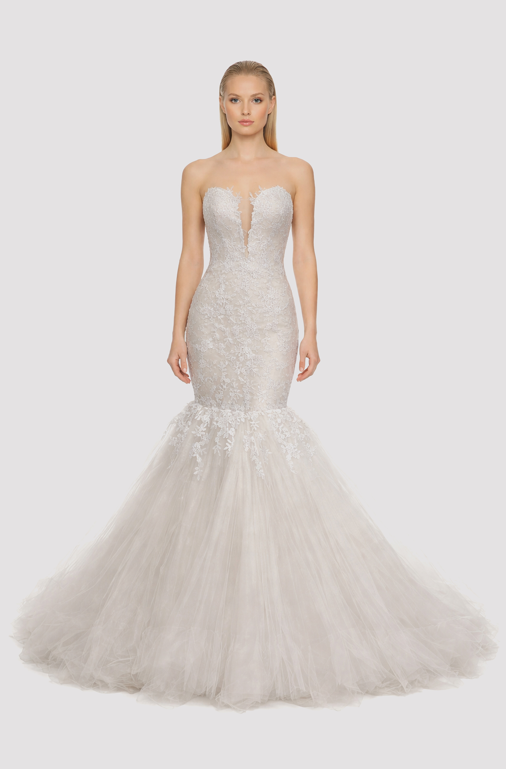 Front view of a woman in an Off-white tulle deep neck mermaid gown with French lace bodice and cascading lace applique 24, image 1