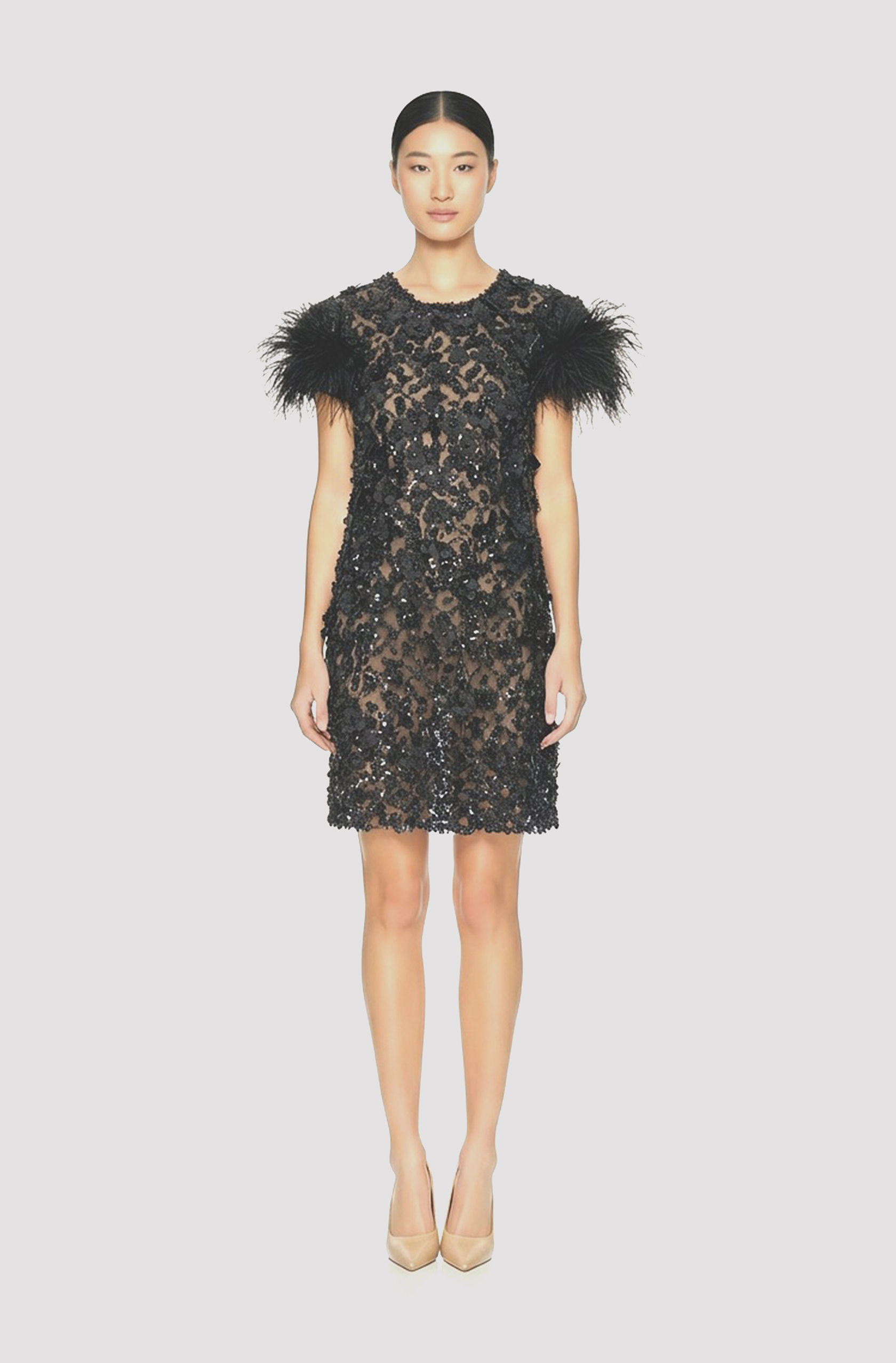 Front view of a woman in a Black hand-beaded sheer mini couture dress with 3D floral appliqués and ostrich feather cuff sleeves 70, image 1